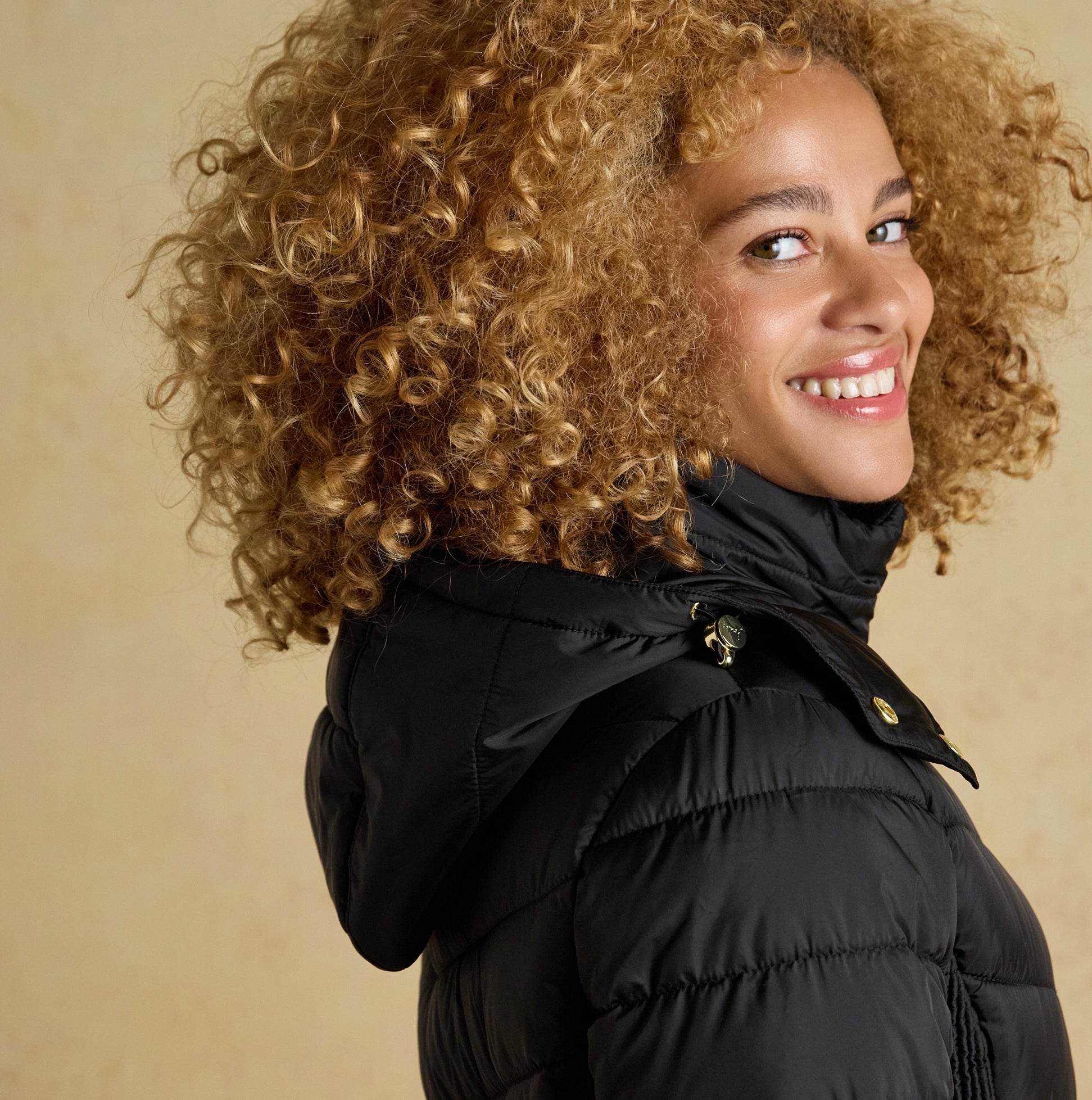 Joules PEMBURY Womens Showerproof Longline Padded Coat with Hood Black side view showing model smiling and wearing coat