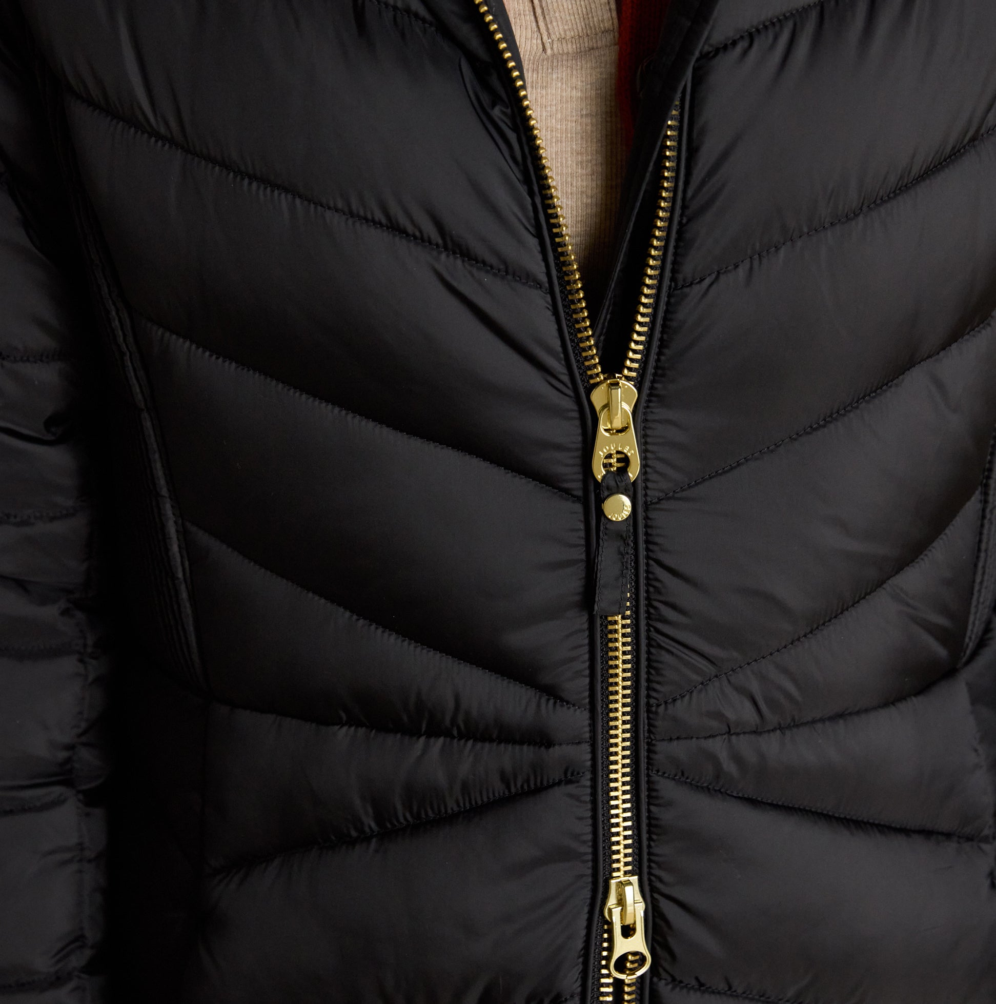 Joules PEMBURY Womens Showerproof Longline Padded Coat with Hood Black detail view showing zip fastening and quilted design.