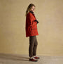 Joules KATHERINE Waterproof Heritage Coat Burnt Orange side view on model, showcasing stylish design and casual fit.