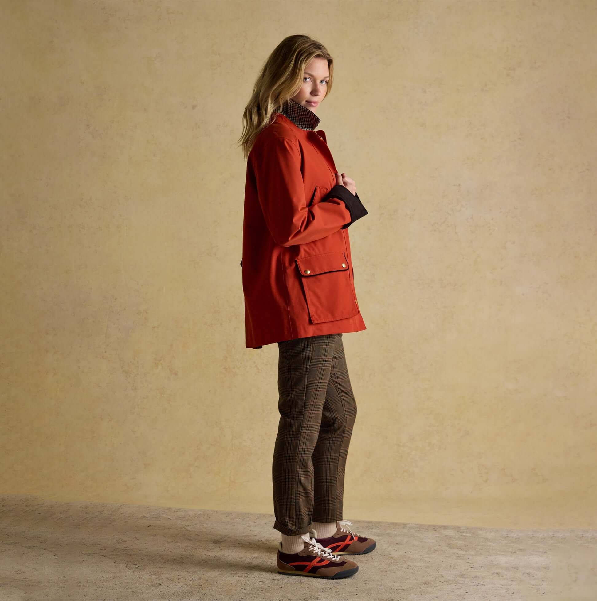 Joules KATHERINE Waterproof Heritage Coat Burnt Orange side view on model, showcasing stylish design and casual fit.