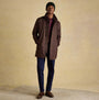 Joules HAMMOND Mens Beanie Green worn with brown coat, front view on model, styled with plaid shirt and blue trousers.
