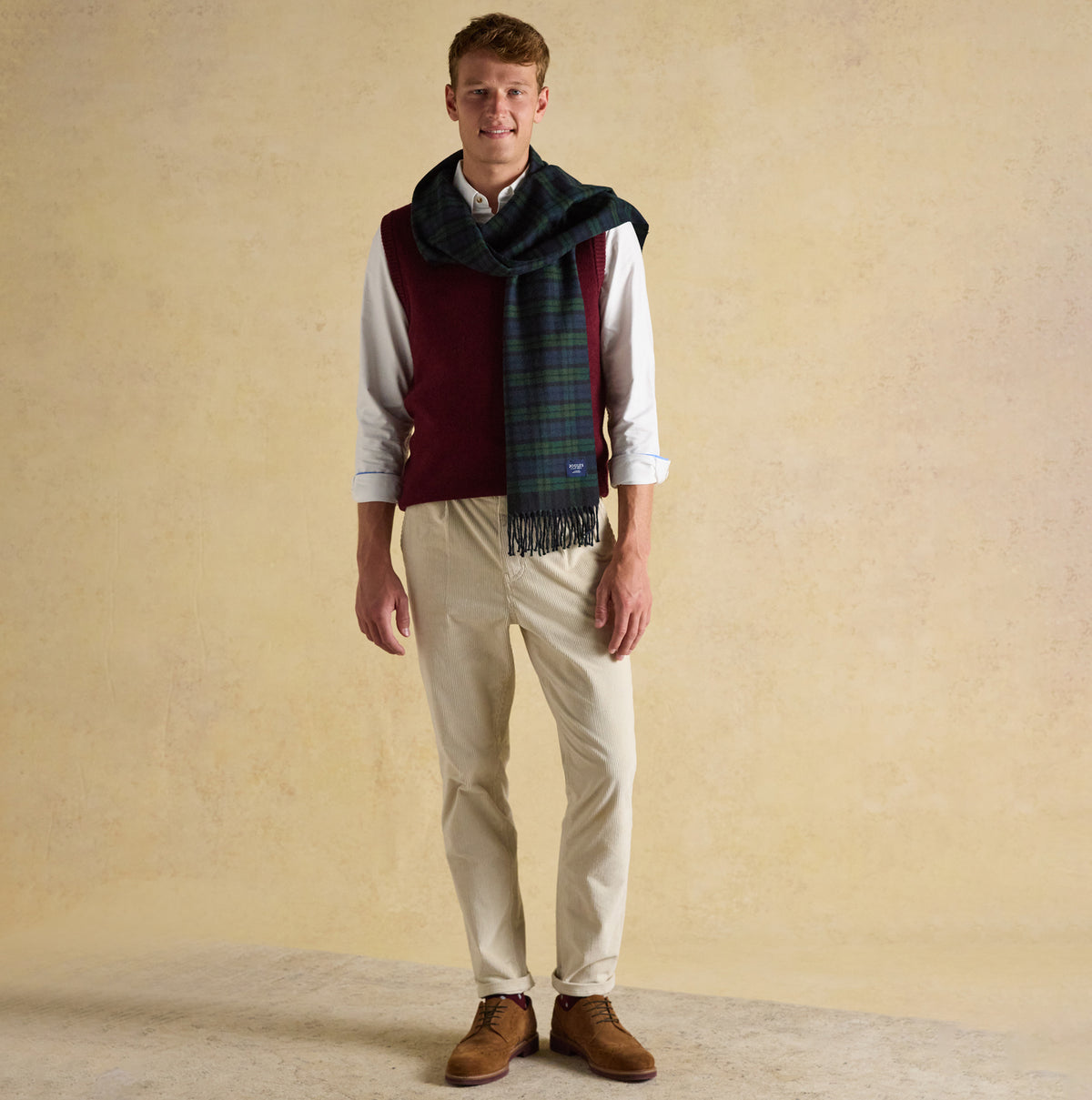 Joules LANGTREE Mens Scarf Navy front view worn by model with burgundy vest and beige trousers, featuring plaid pattern.