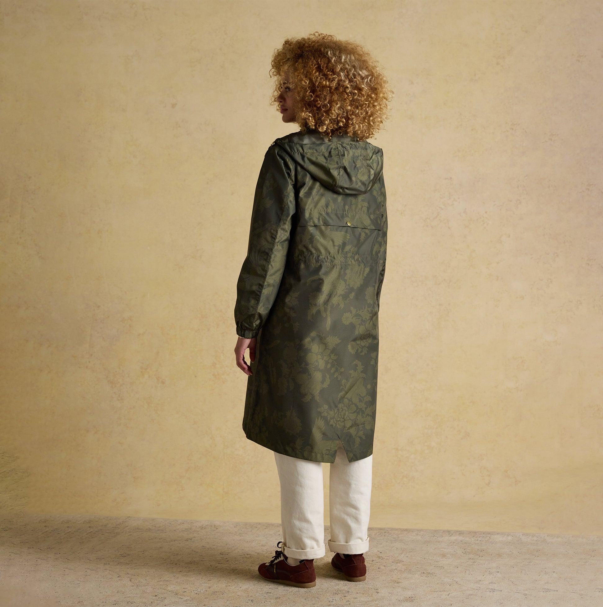 Joules HOLKHAM Waterproof Packable Raincoat With Hood Green back view with hood up on model, showcasing relaxed fit and recycled material.