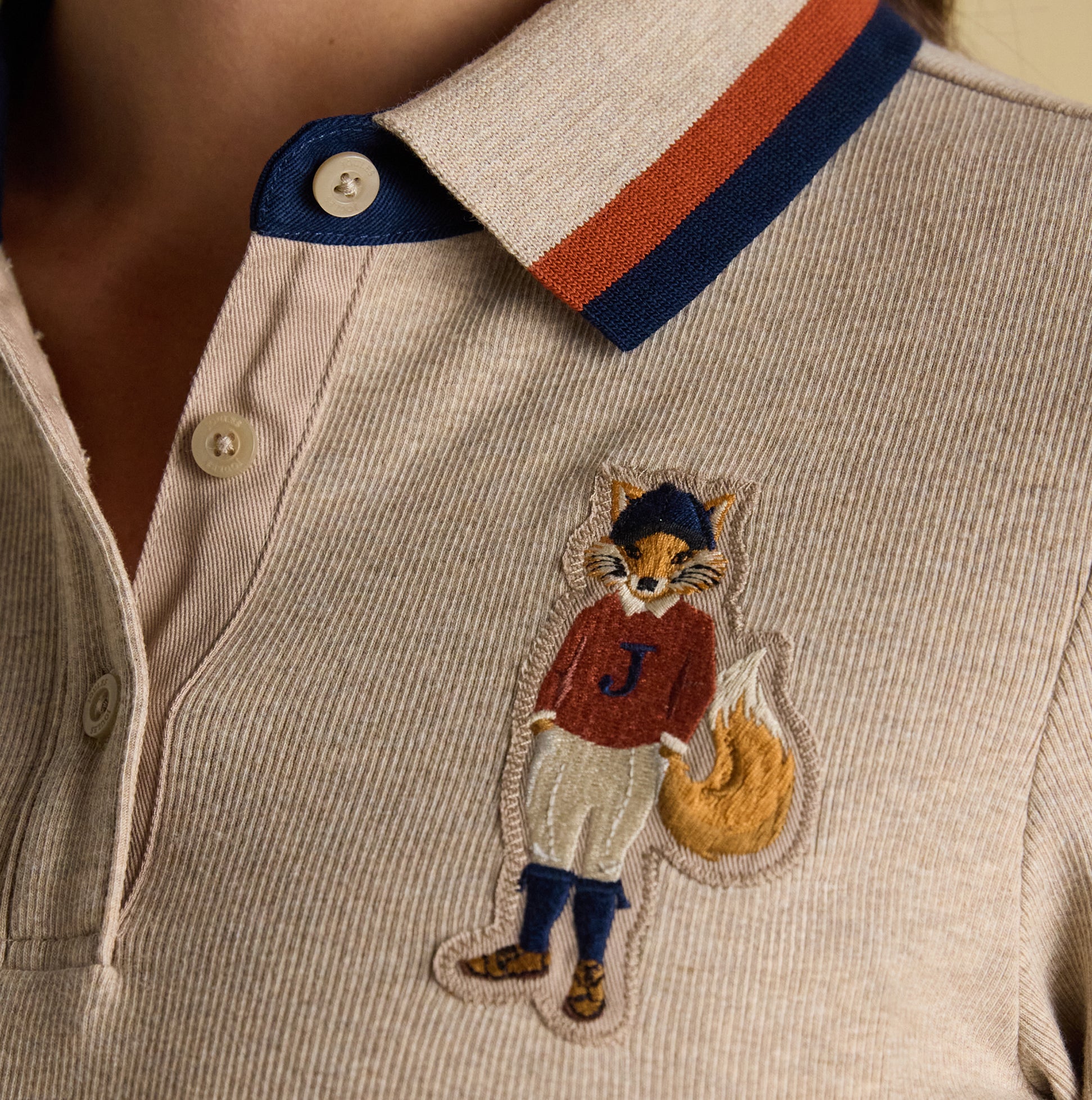 Joules FAIRFIELD JONTY Womens Polo Shirt Neutral detail view showcasing embroidered fox design on collar.