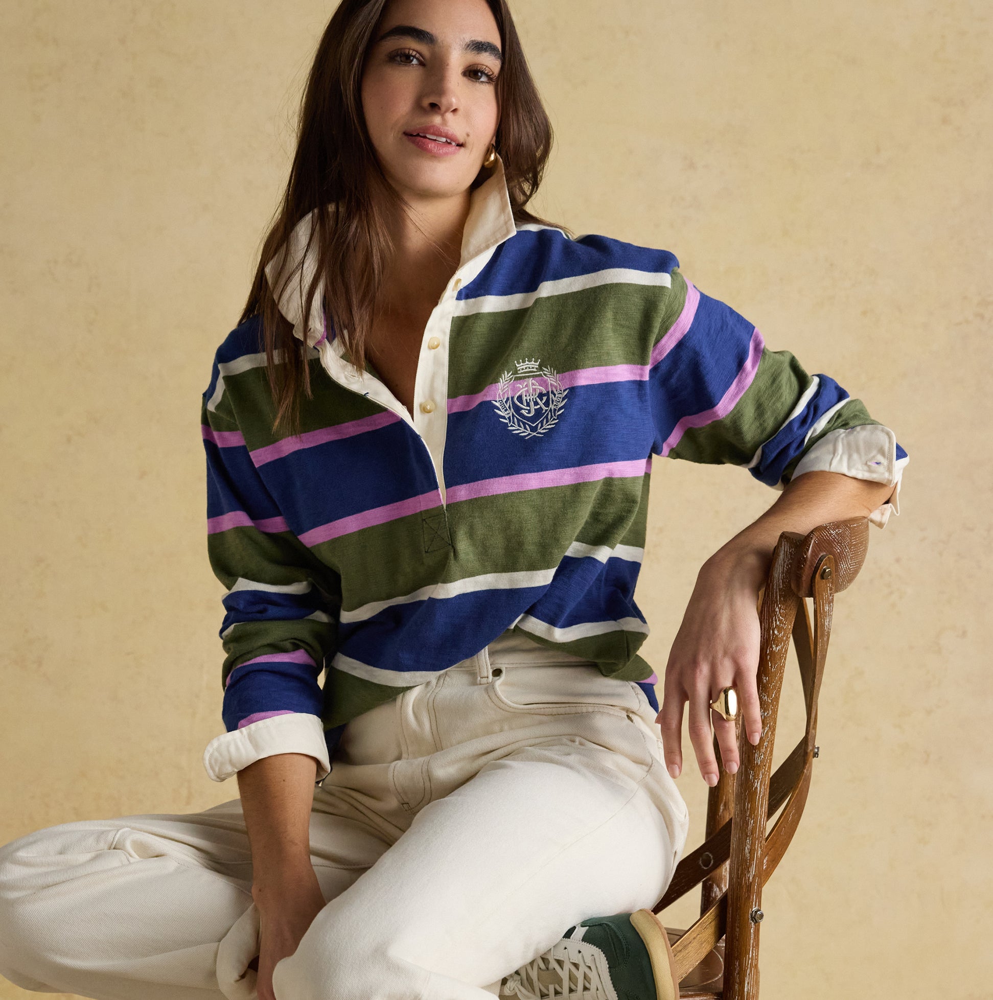 Joules LARA SLUB Womens Rugby Shirt Green front view showing stripes and logo, styled with casual white jeans.