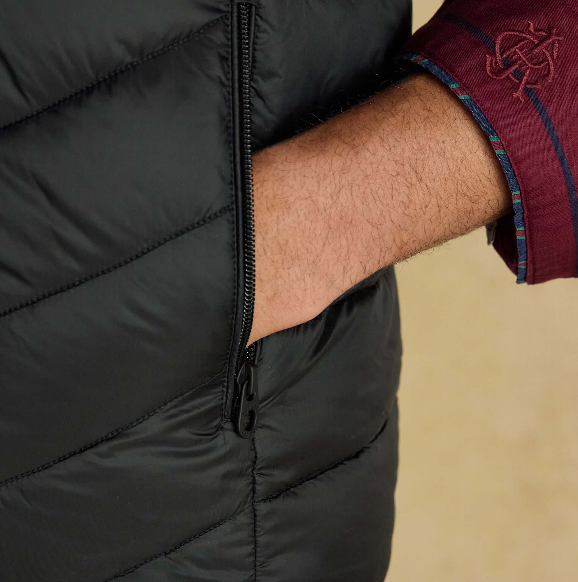 Joules GARRETT Mens Showerproof Padded Gilet Black detail view of zip pocket and sleeve.