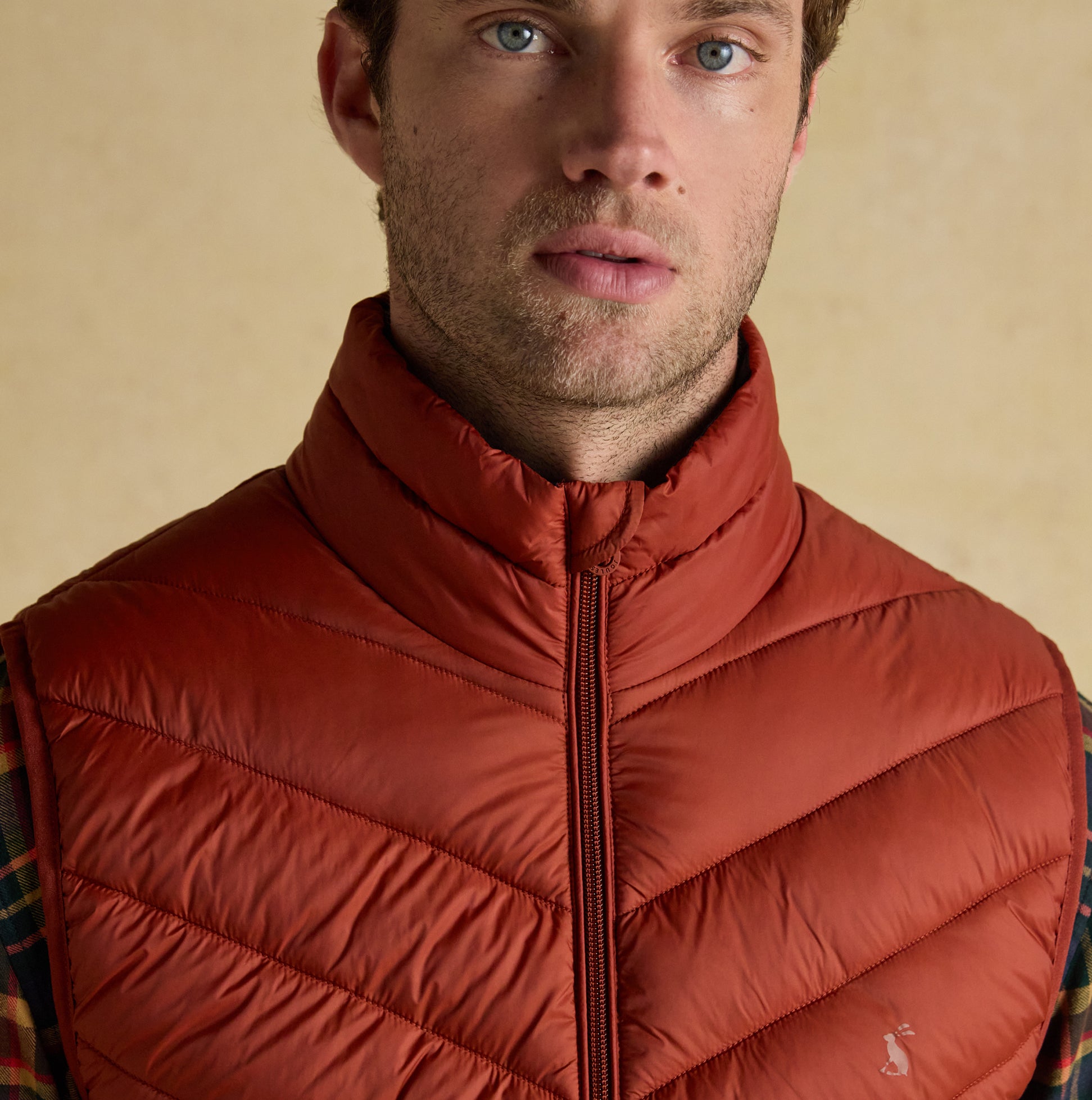 Joules GARRETT Mens Showerproof Padded Gilet Orange front view, showcasing zip closure and padded design.