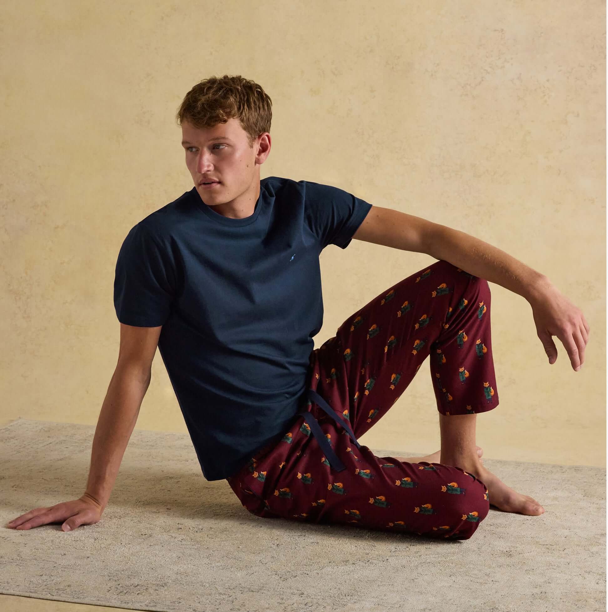 Joules DOZER Mens Pyjama Trousers Burgundy Red front view, relaxed fit cotton loungewear with navy t-shirt.