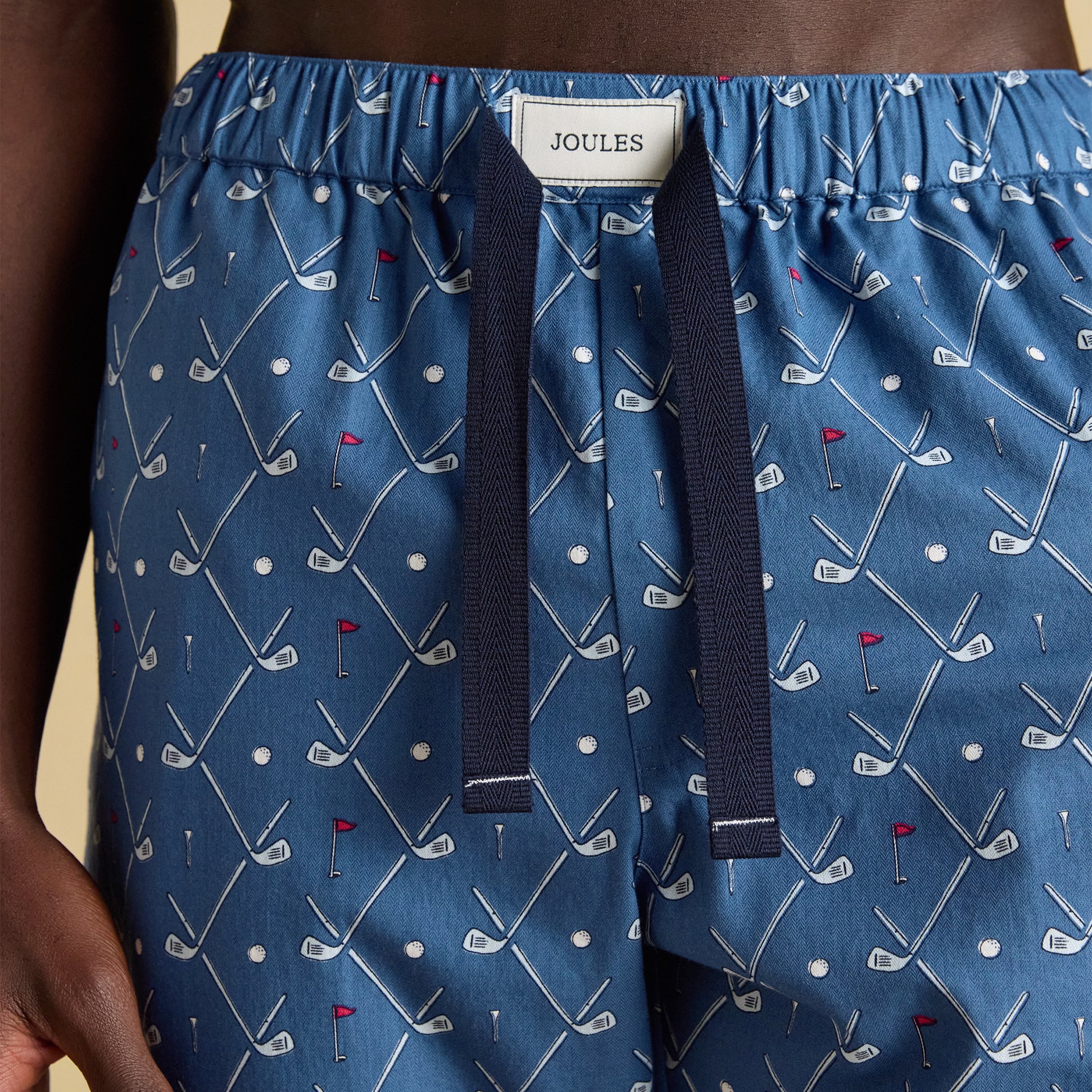 Joules DOZER Mens Pyjama Bottoms Blue close-up view showing golf pattern and elastic waistband.