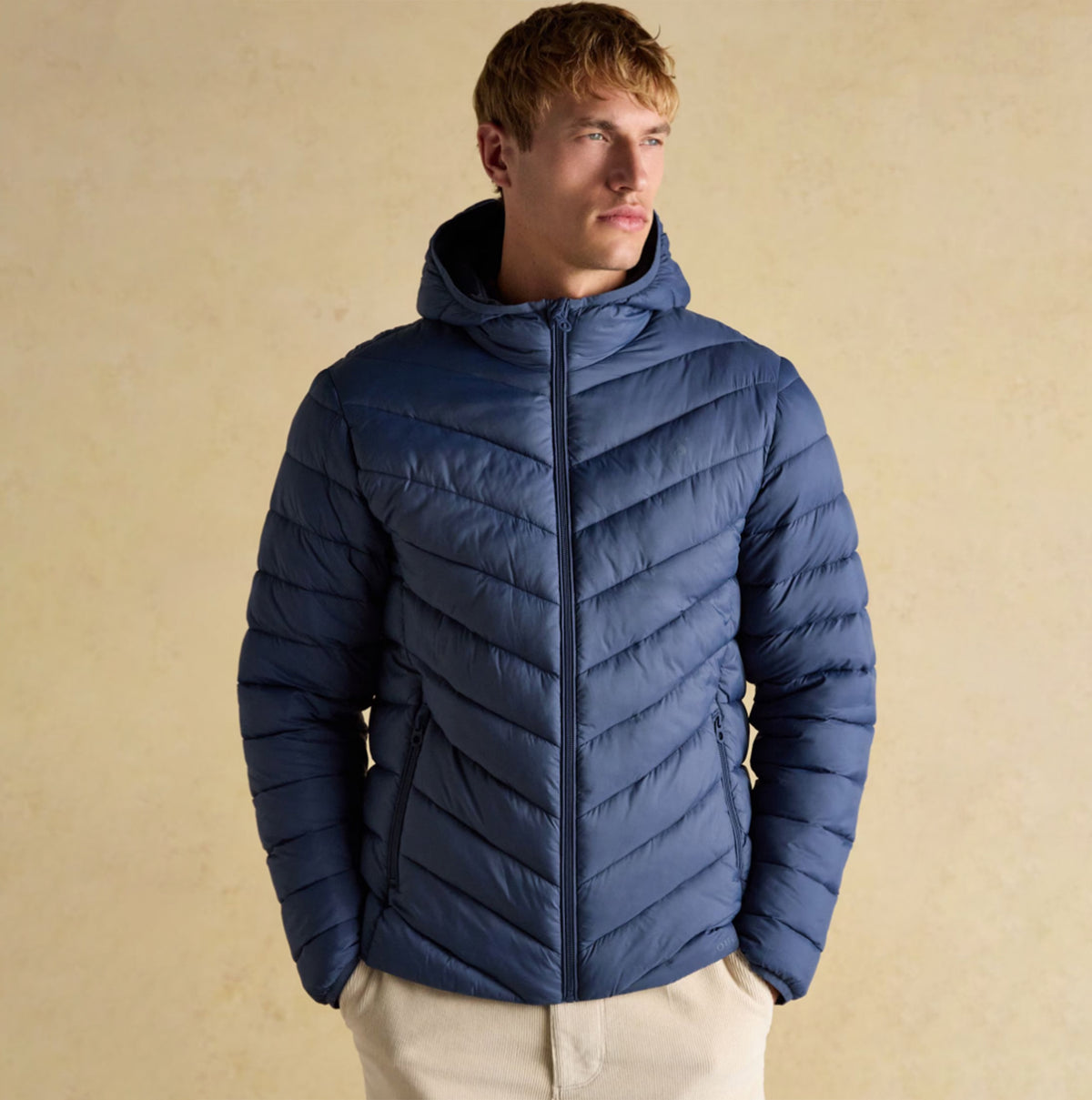 Joules Garrett Blue Showerproof Padded Jacket front view, featuring zip closure and a hood, ideal for cold weather.
