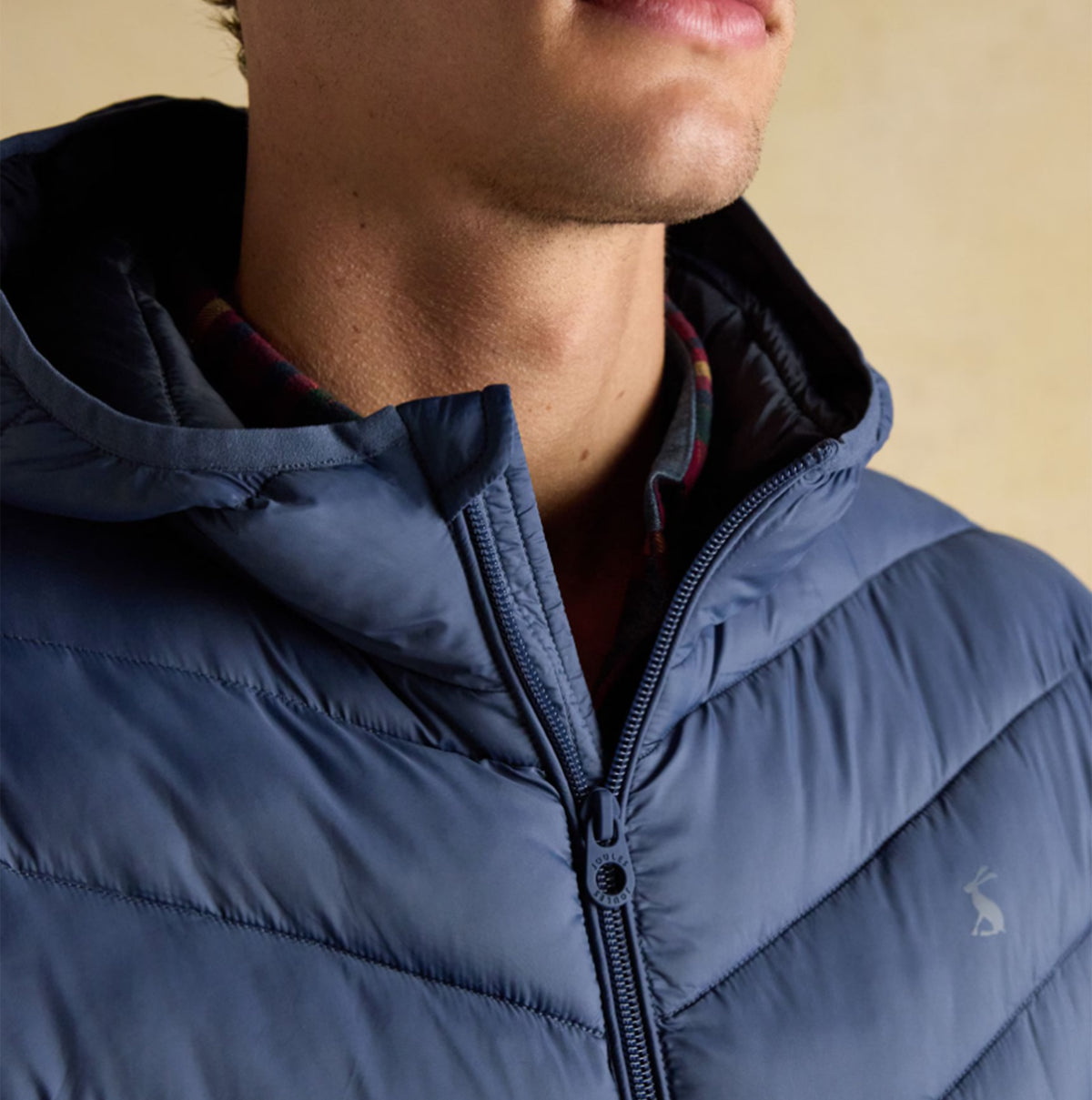 Joules Garrett Blue Showerproof Padded Jacket close-up view showcasing the zip and hood design.