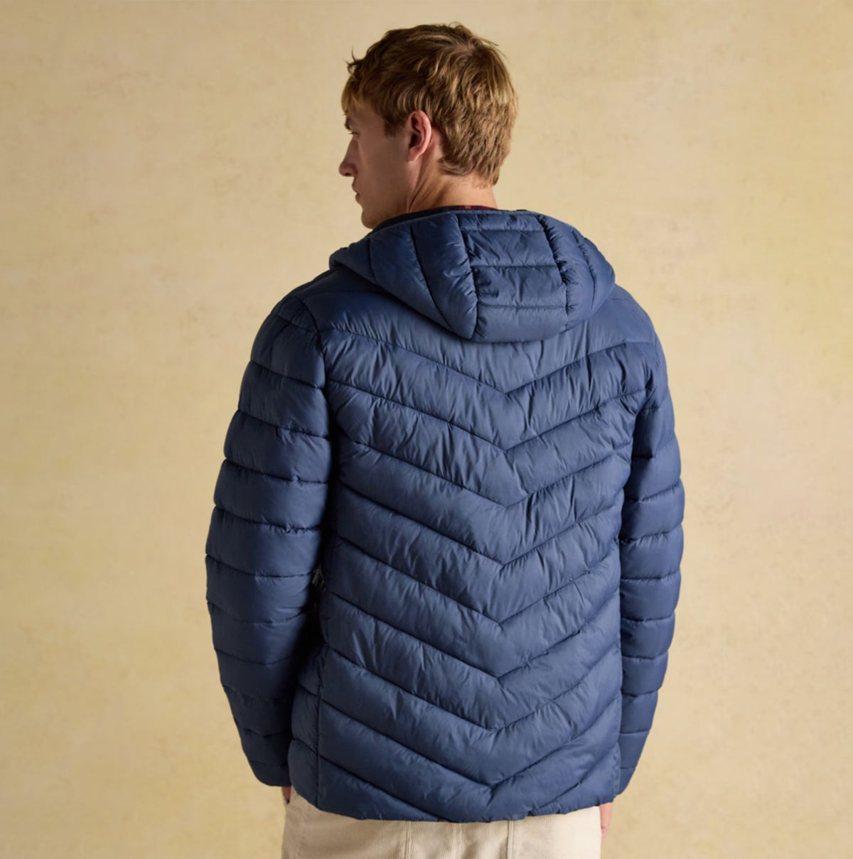 Joules Garrett Blue Showerproof Padded Jacket back view showcasing chevron design and hood.