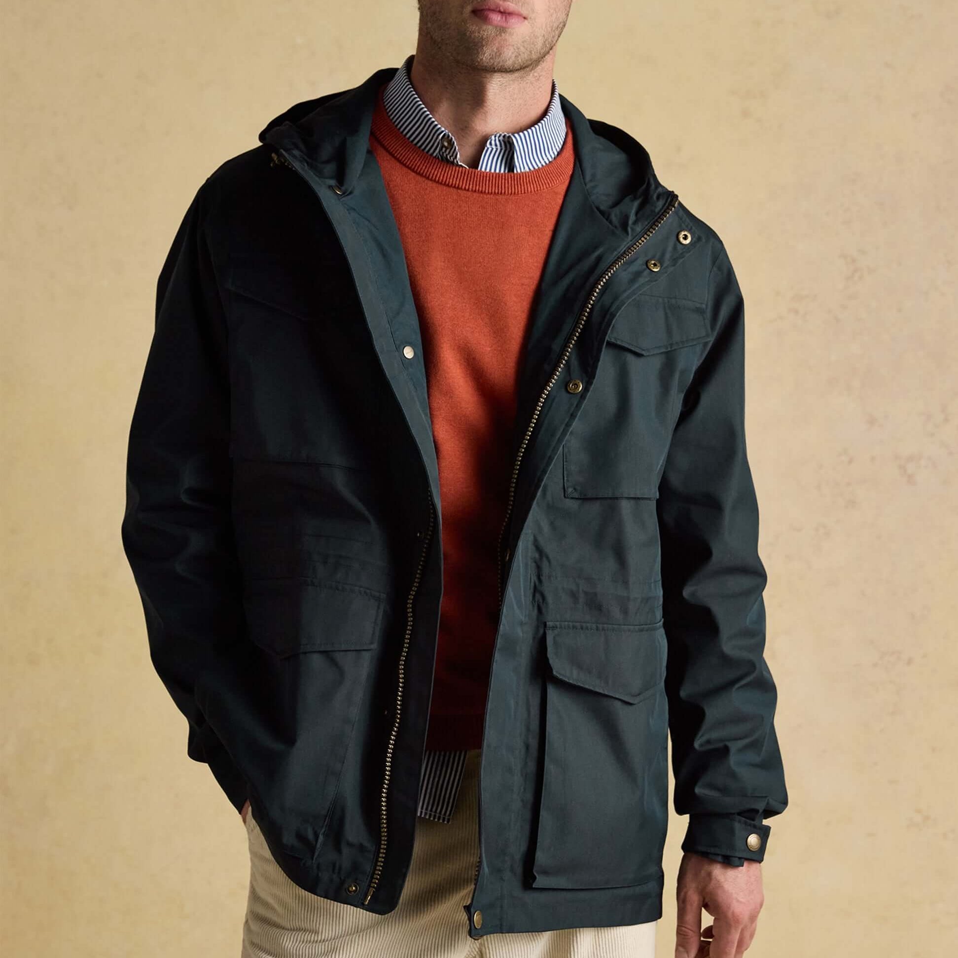 Joules PORTMAN Green Waterproof Raincoat Navy front view model wearing with orange sweater.