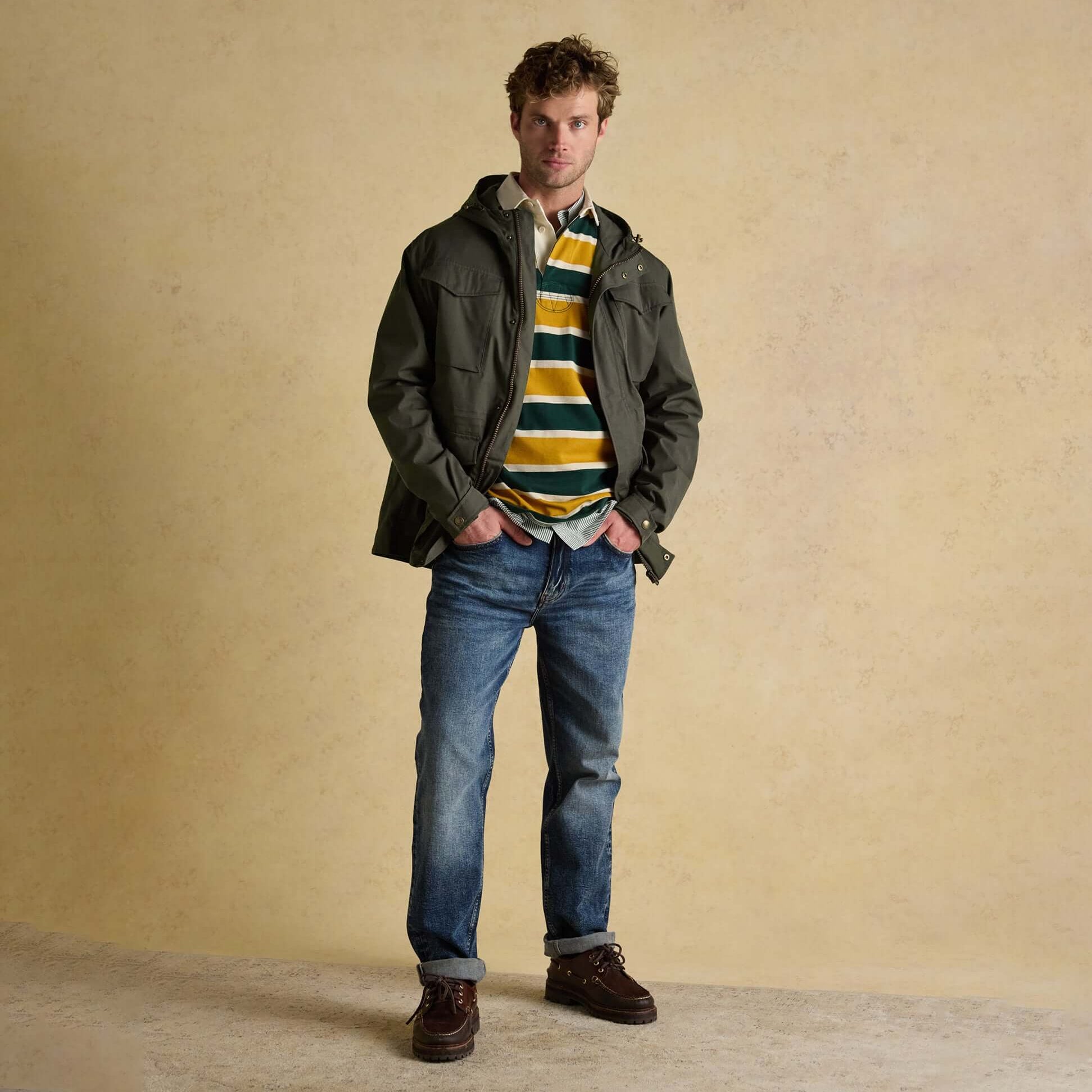 Joules PORTMAN Mens Green Waterproof Raincoat Green front view worn over striped shirt and jeans.