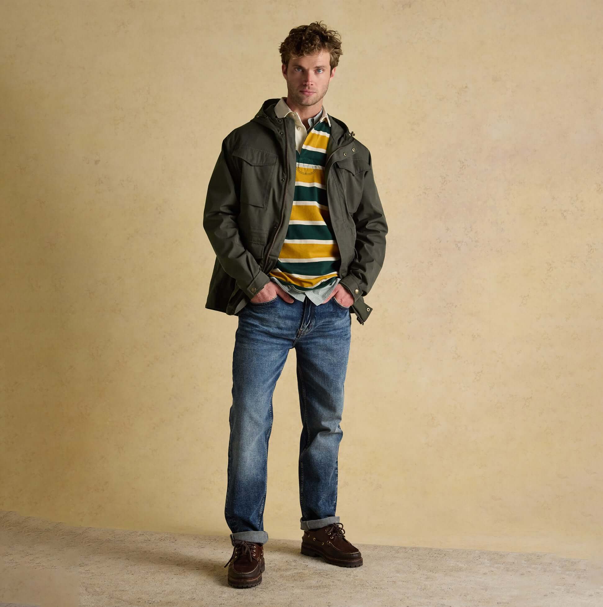 Joules PORTMAN Mens Green Waterproof Raincoat Green front view worn over striped shirt and jeans.