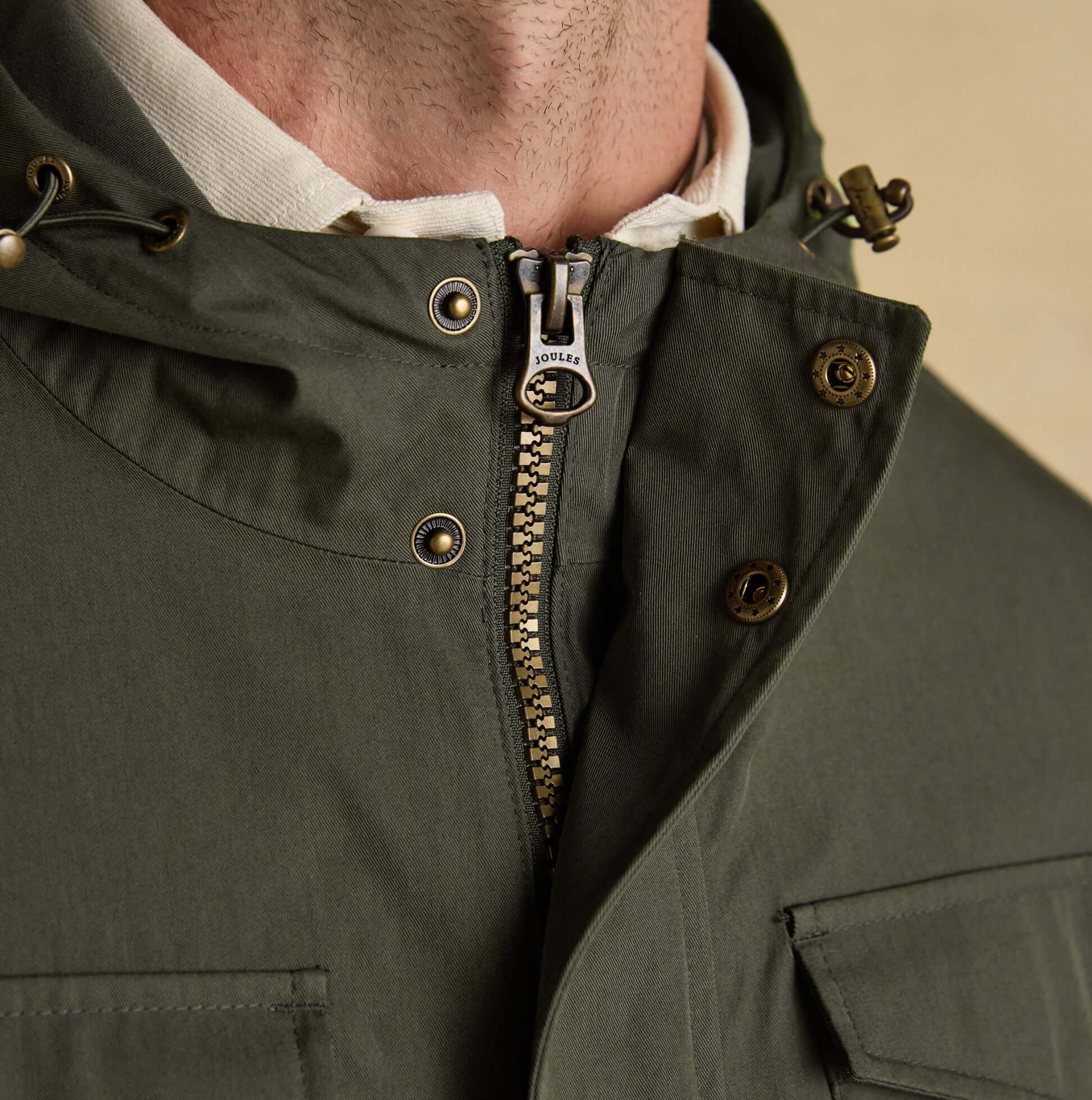 Joules PORTMAN Mens Green Waterproof Raincoat Green detail view of zipper and fastenings on jacket.