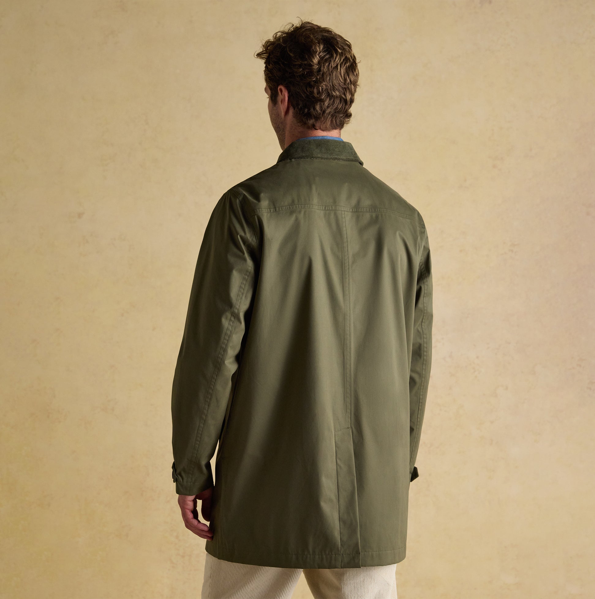 Joules SANDFORD Mens Waterproof Raincoat Green back view, showcasing the button and zip fastening details, with a regular fit.