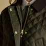 Joules BEATRIX Womens Showerproof Quilted Coat Khaki Green detail view showing zipper and button closure.