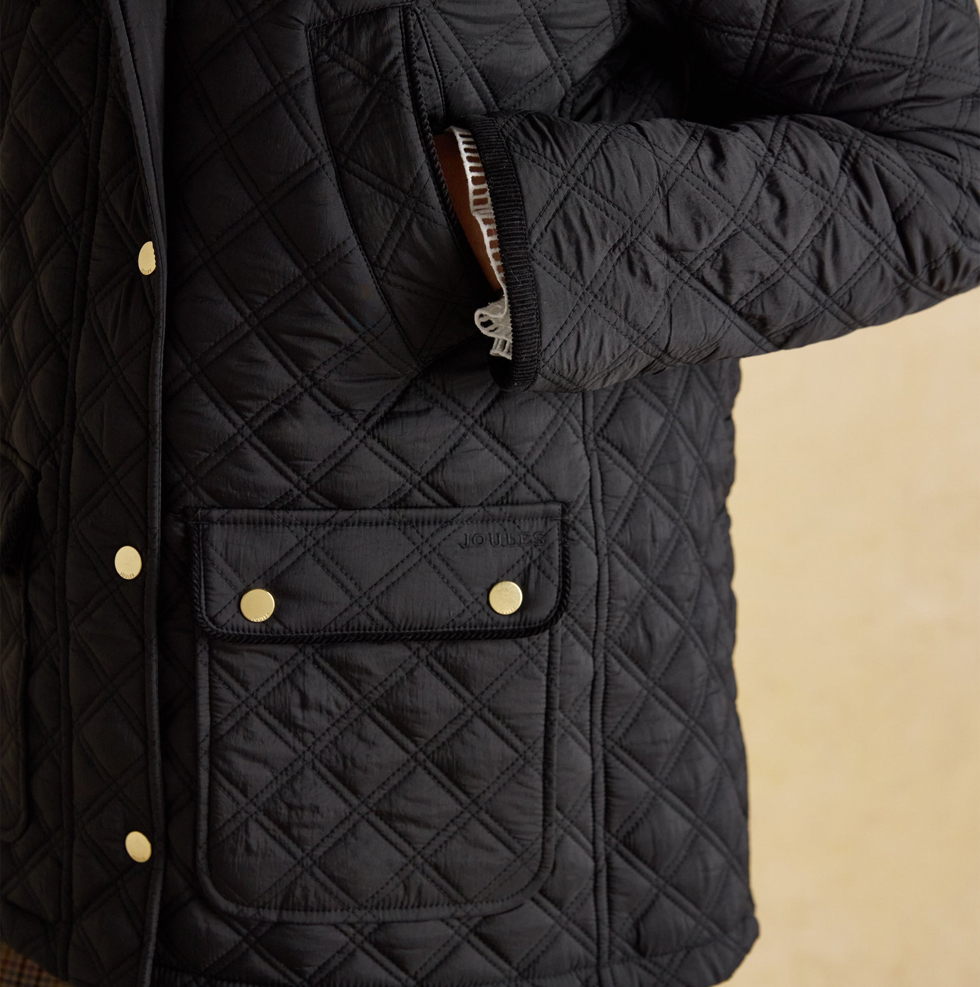Joules BEATRIX Womens Heritage Quilted Coat Black detail view showcasing quilted texture and button closure.
