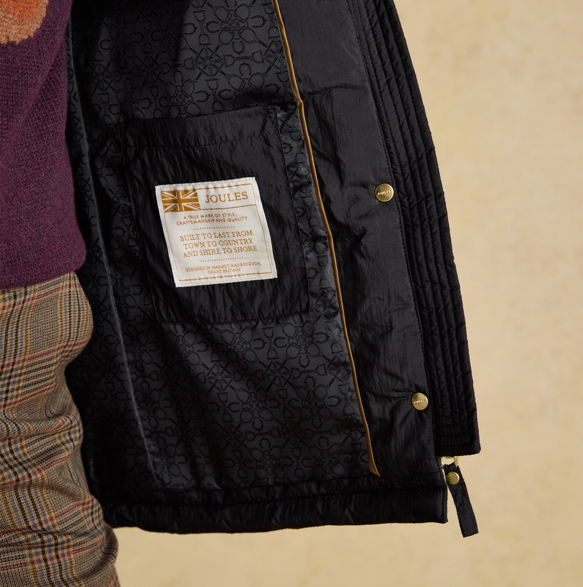 Joules BEATRIX Womens Heritage Quilted Coat Black detail view of interior lining and brand label.