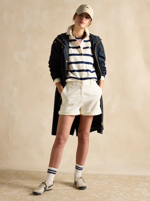 Joules HOLKHAM Womens Raincoat Navy Paisley front view worn over casual outfit with white shorts and striped polo.