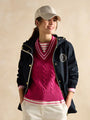Joules Holt Waterproof Packable Raincoat with Hood Navy, front view worn over a pink knit sweater, stylish and functional.