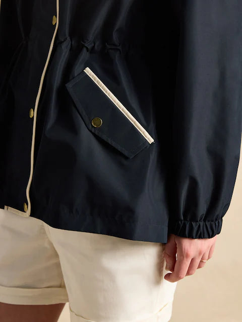 Joules Holt Waterproof Packable Raincoat with Hood Navy detail view showcasing pocket and cuff.