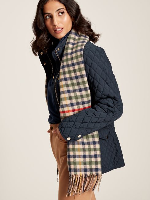 Joules LANGTREE Womens Scarf Henson Check styled with a navy quilted jacket, showcasing the heritage check pattern and tasselled ends.