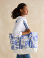Joules PROMENADE Womens Tote Bag Blue Toile side view with model, featuring lightweight cotton and striped straps.