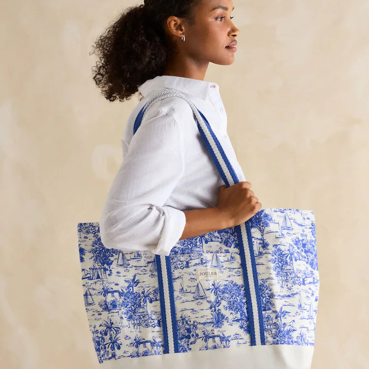 Joules PROMENADE Womens Tote Bag Blue Toile side view with model, featuring lightweight cotton and striped straps.