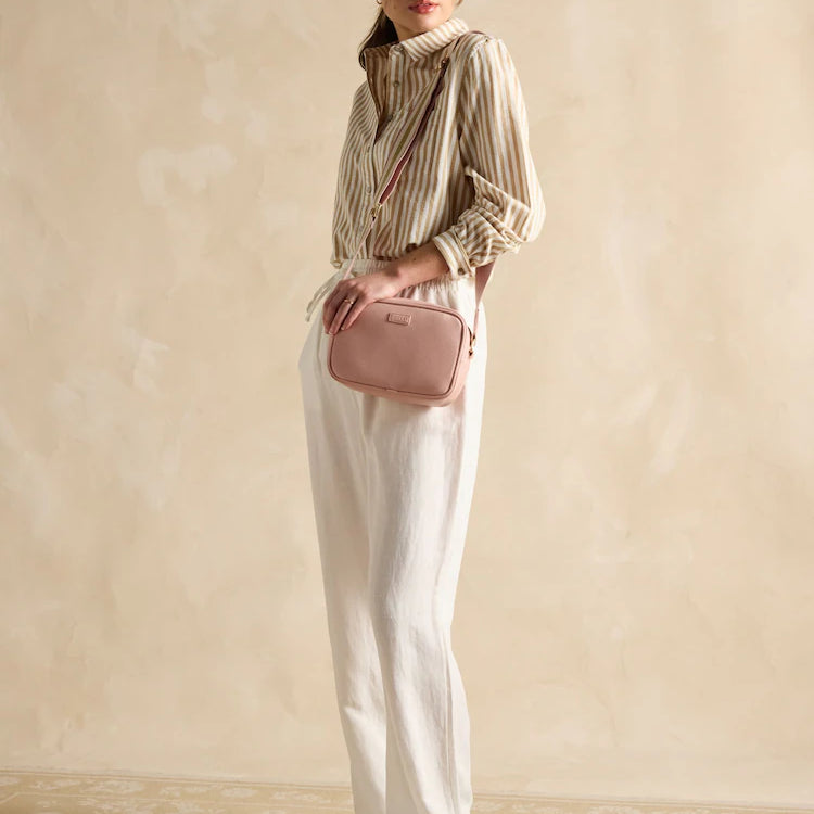 Joules TRENT Womens Cross Body Bag Pale Pink worn by model in a side view against a light background, showcasing stylish outfit.