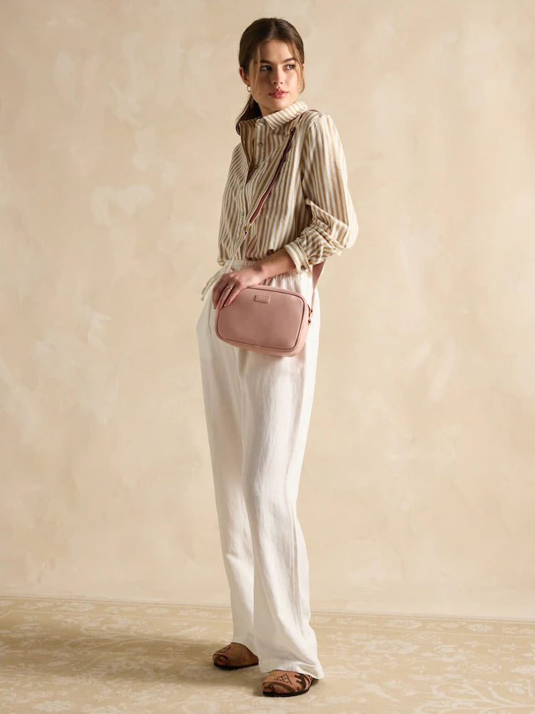 Joules TRENT Womens Cross Body Bag Pale Pink worn by model in a side view against a light background, showcasing stylish outfit.