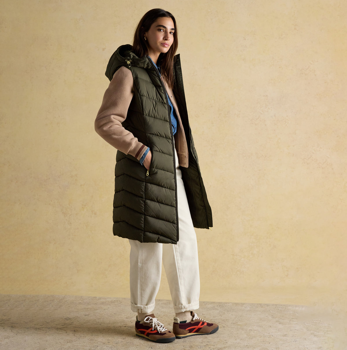 Joules MOORSDALE Womens Longline Showerproof Padded Gilet Green side view on model, featuring zip closure and hood.
