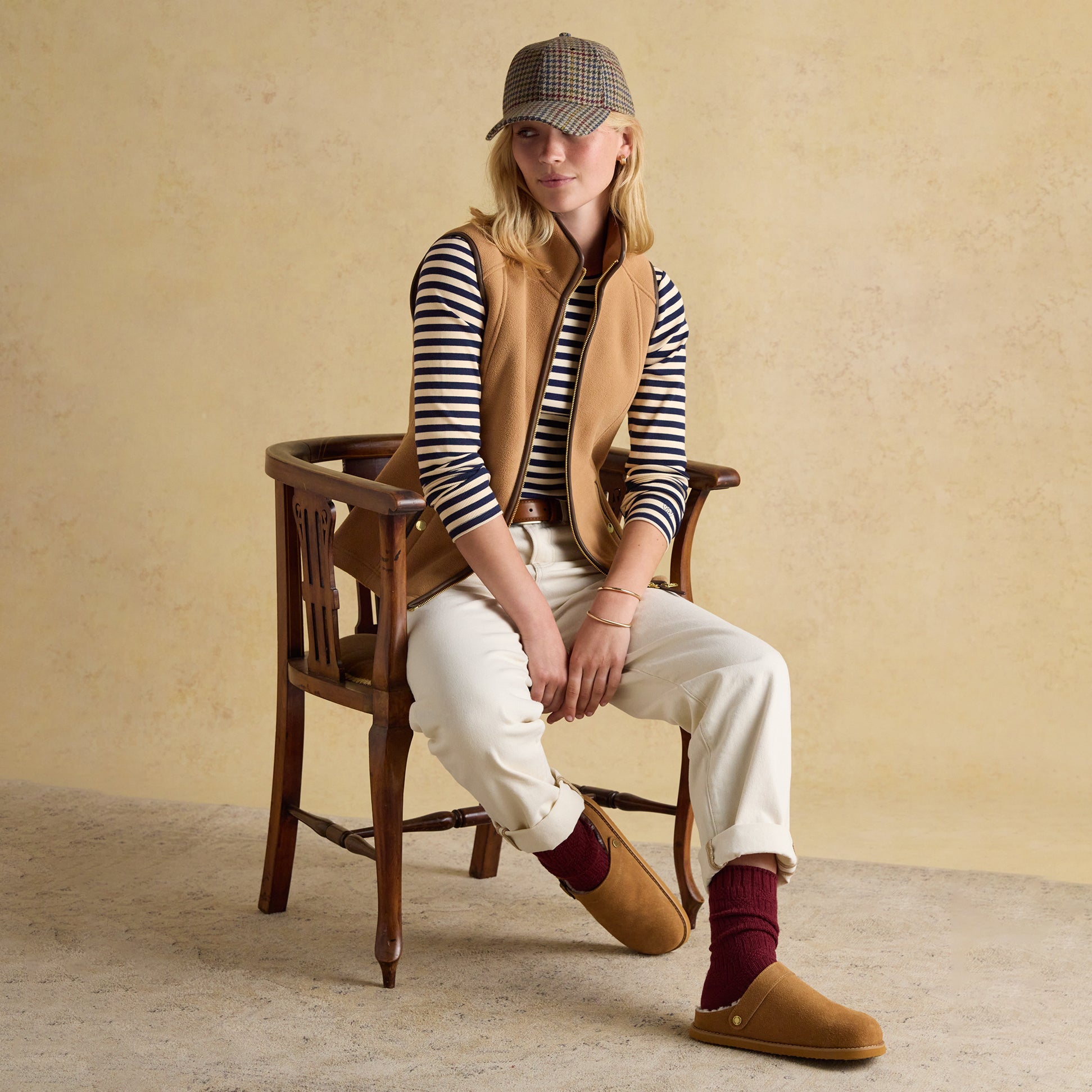 Joules HERITAGE FLEECE Womens Gilet Tan, front view, styled with a striped shirt and seated on a chair.