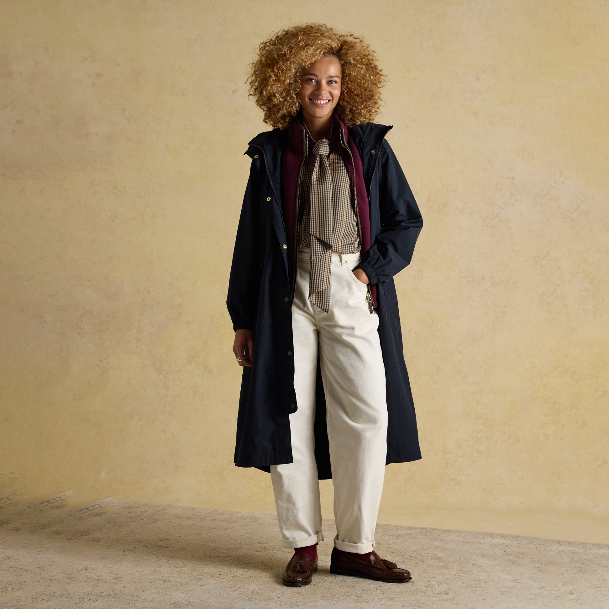 Joules HENSLEY Womens Longline Waterproof Coat Navy front view with model, featuring button and zip closure, relaxed fit.