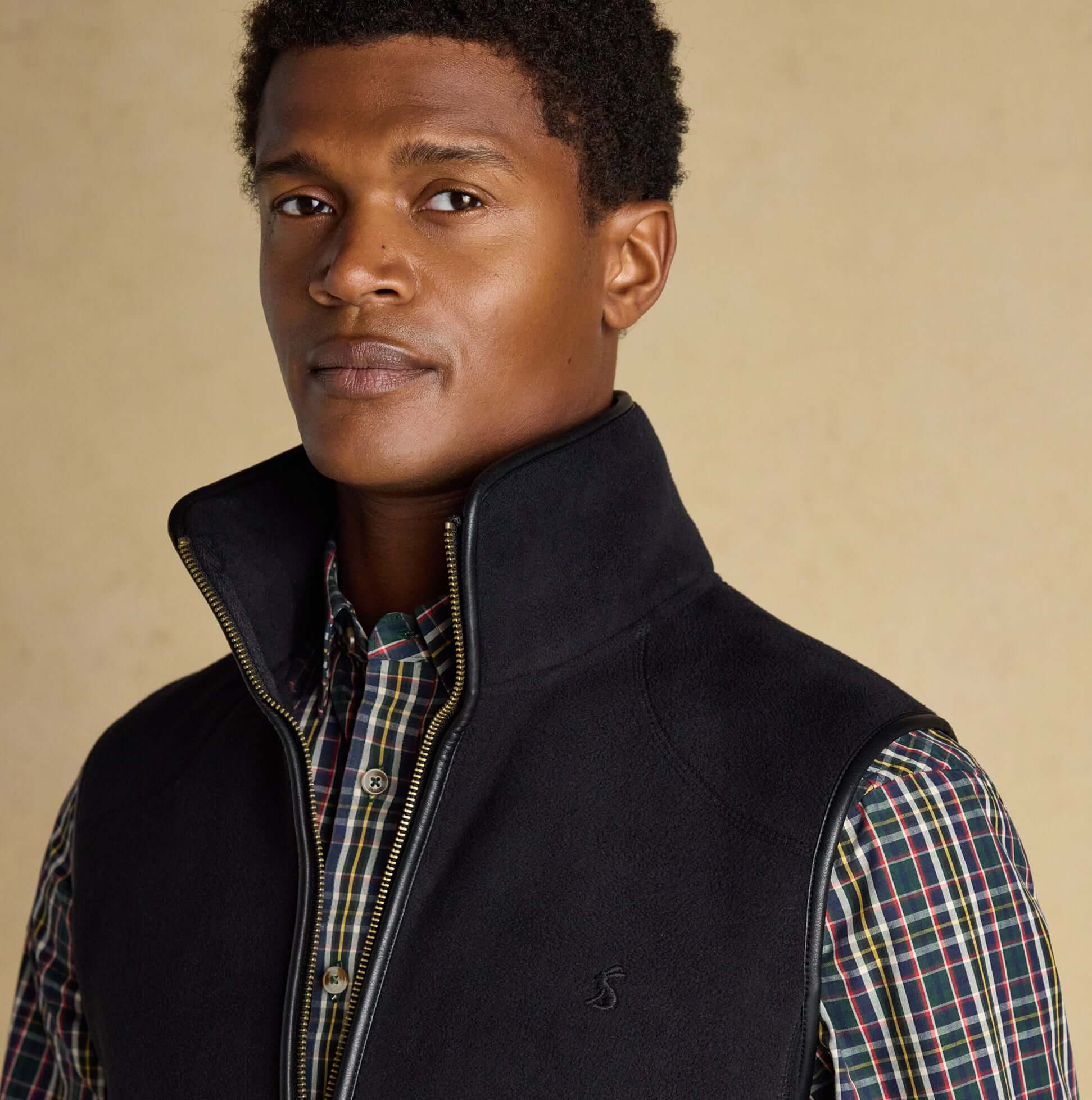 Joules HERITAGE FLEECE Mens Gilet Black front view on model showcasing zip fastening and sleeveless design.