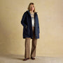 Joules PORTWELL Waterproof Hoodie Raincoat With Adjustable Waist Navy front view, model wearing navy raincoat with long sleeves.