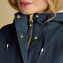 Joules PORTWELL Waterproof Hoodie Raincoat With Adjustable Waist Navy detail view highlighting zipper and gold buttons.