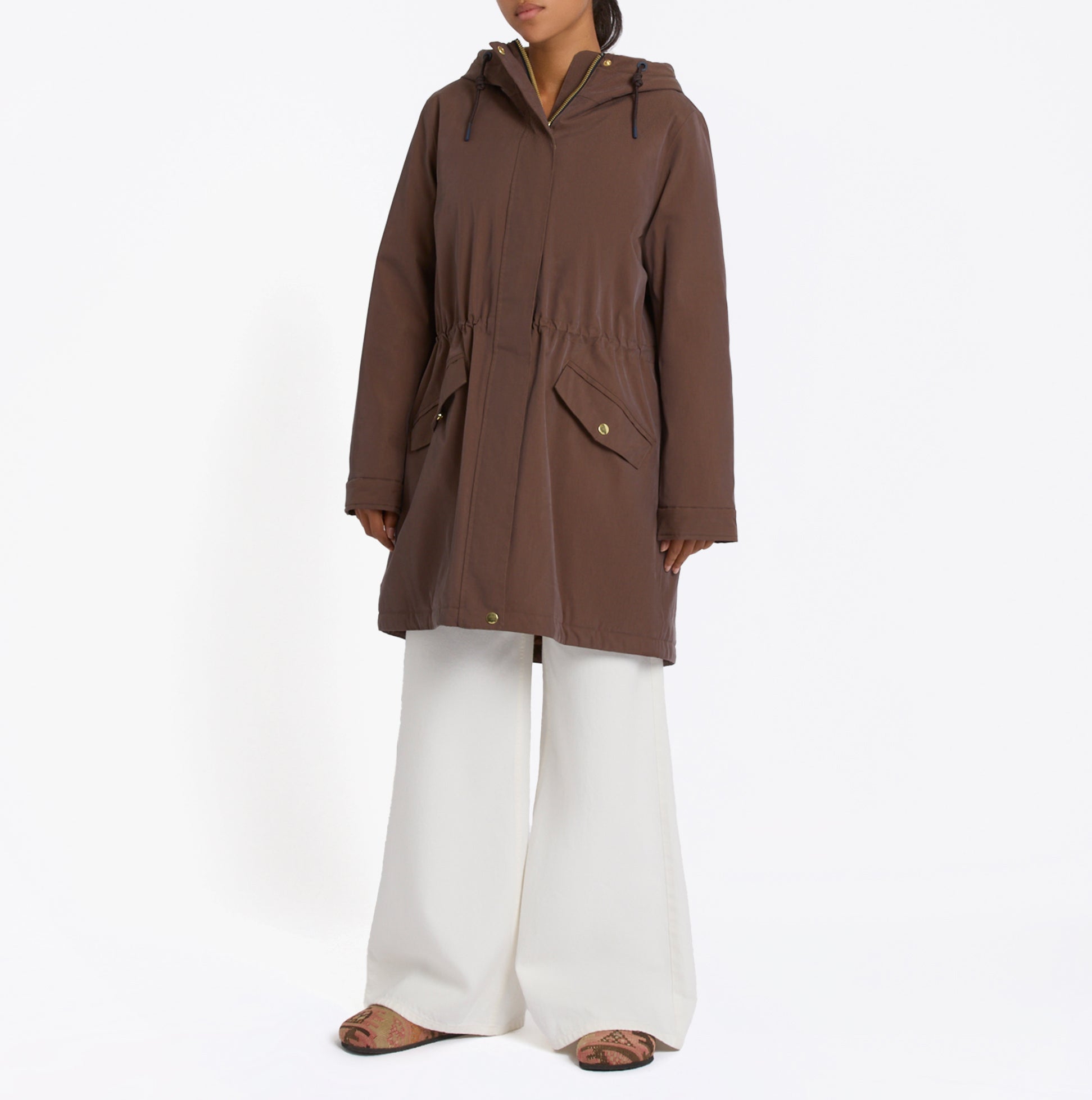 Joules PORTWELL Waterproof Hoodie Raincoat With Adjustable Waist Brown front view on model with white pants