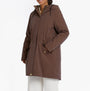 Joules PORTWELL Waterproof Hoodie Raincoat With Adjustable Waist Brown front view on model, showcasing hood and adjustable waist feature.