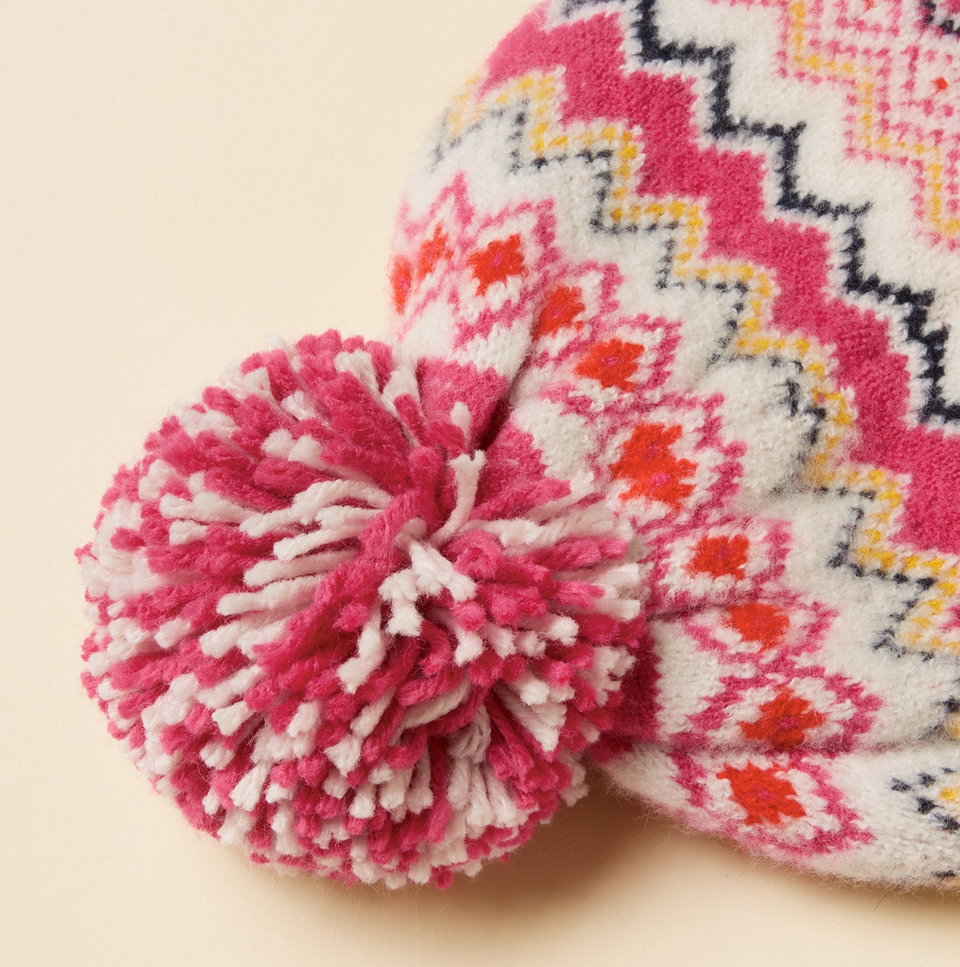 Joules KARA BOBBLE Womens Beanie Hat Pink detail view featuring vibrant pompom and intricate design.