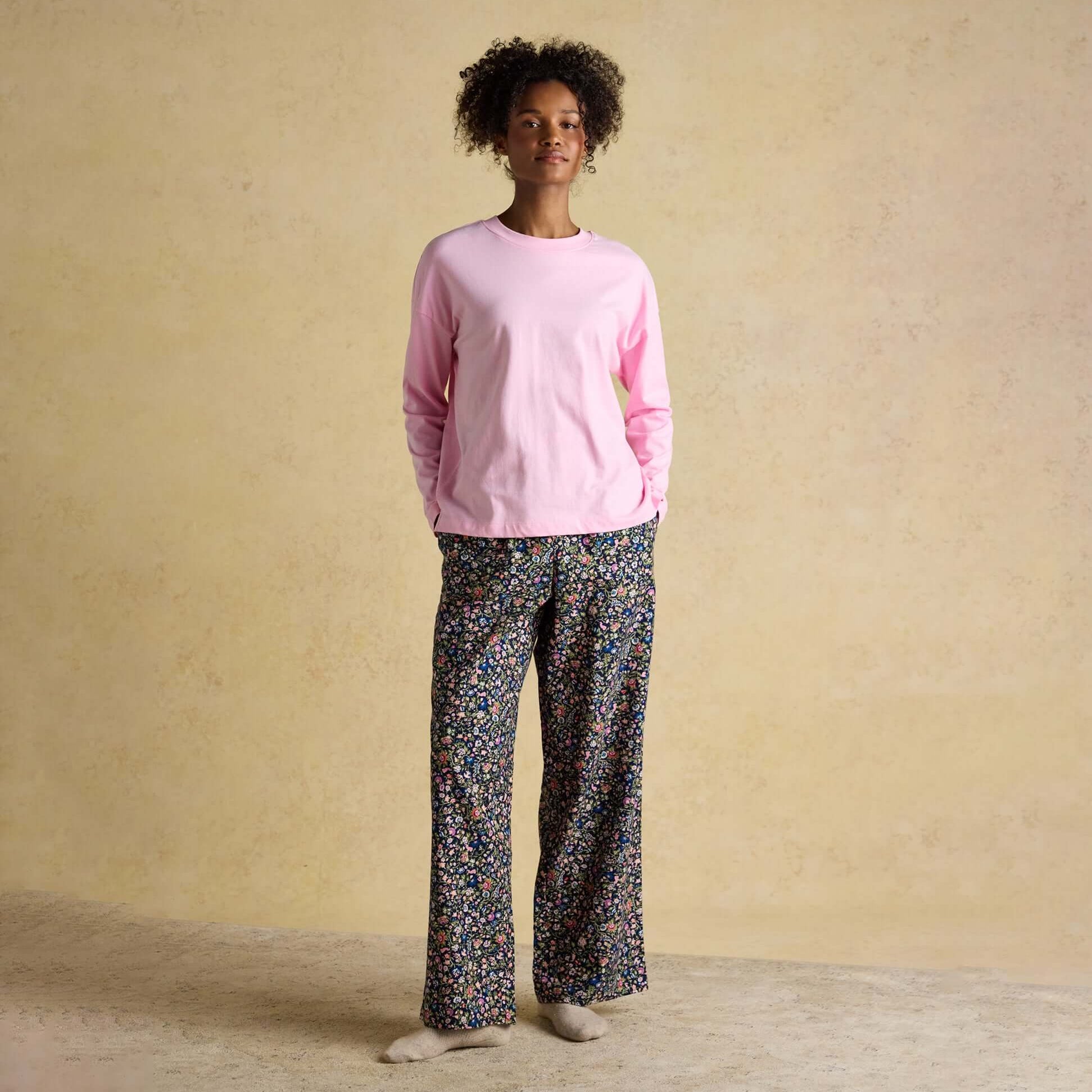 Joules JERSEY Pyjama Top Womens Sweatshirts Pink front view, showcasing the top worn with floral pyjama pants.