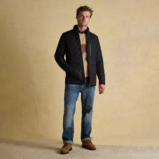 Joules MAYNARD Mens Diamond Quilted Jacket Black front view on model standing with jeans.