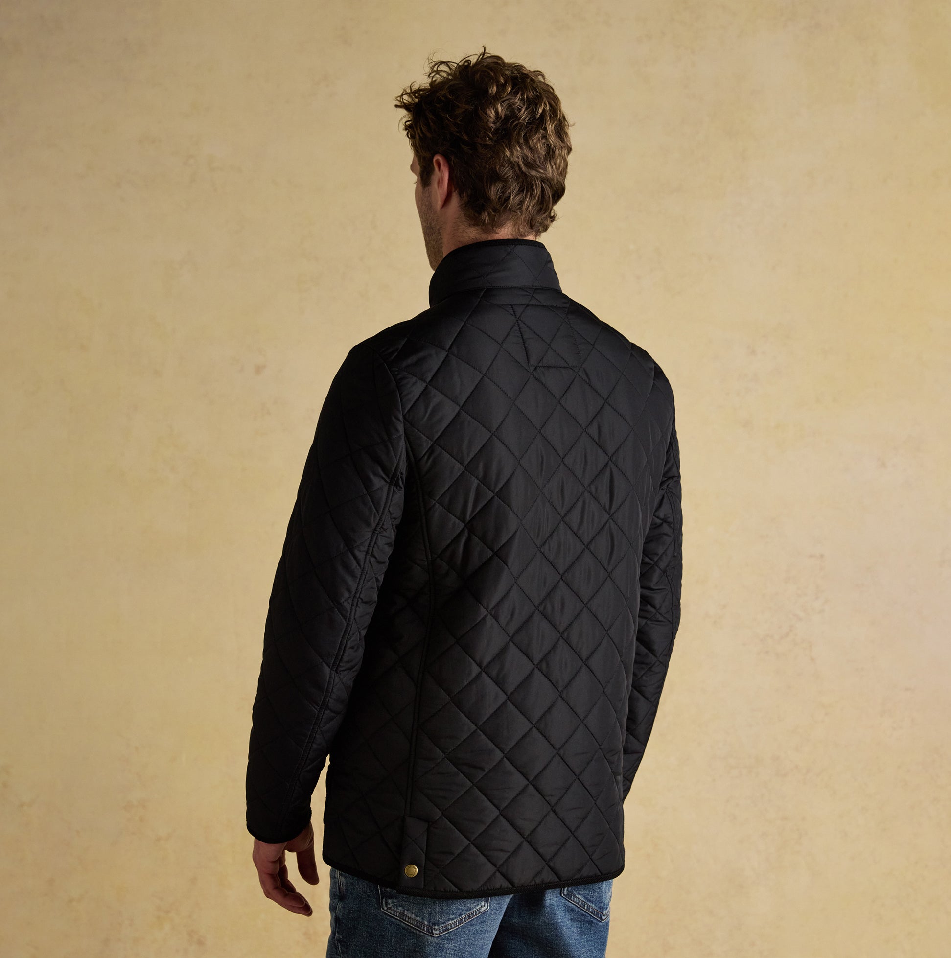 Joules MAYNARD Mens Diamond Quilted Jacket Black back view on model, featuring a zip closure and diamond quilted pattern.