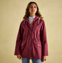 Joules PORTWELL Womens Raincoat Port front view, featuring adjustable hood and waist in burgundy color.