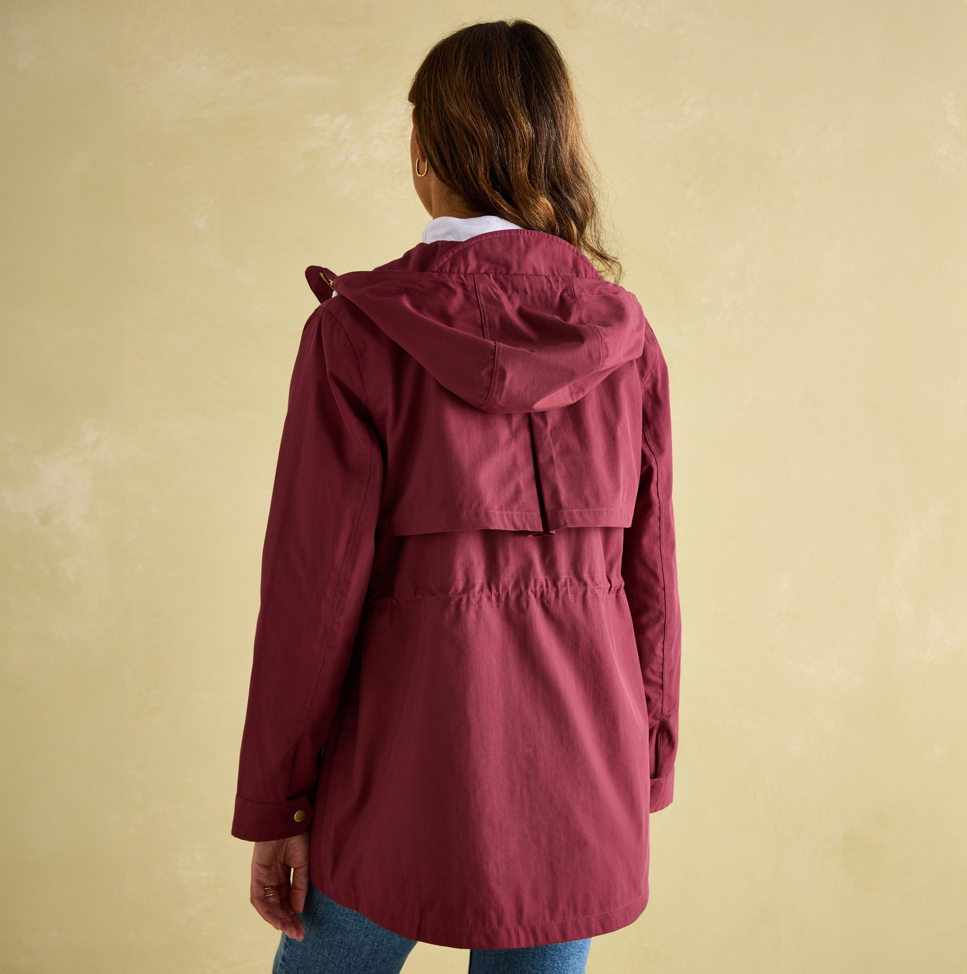 Joules PORTWELL Womens Raincoat Port back view showcasing adjustable hood and cinched waist detail.