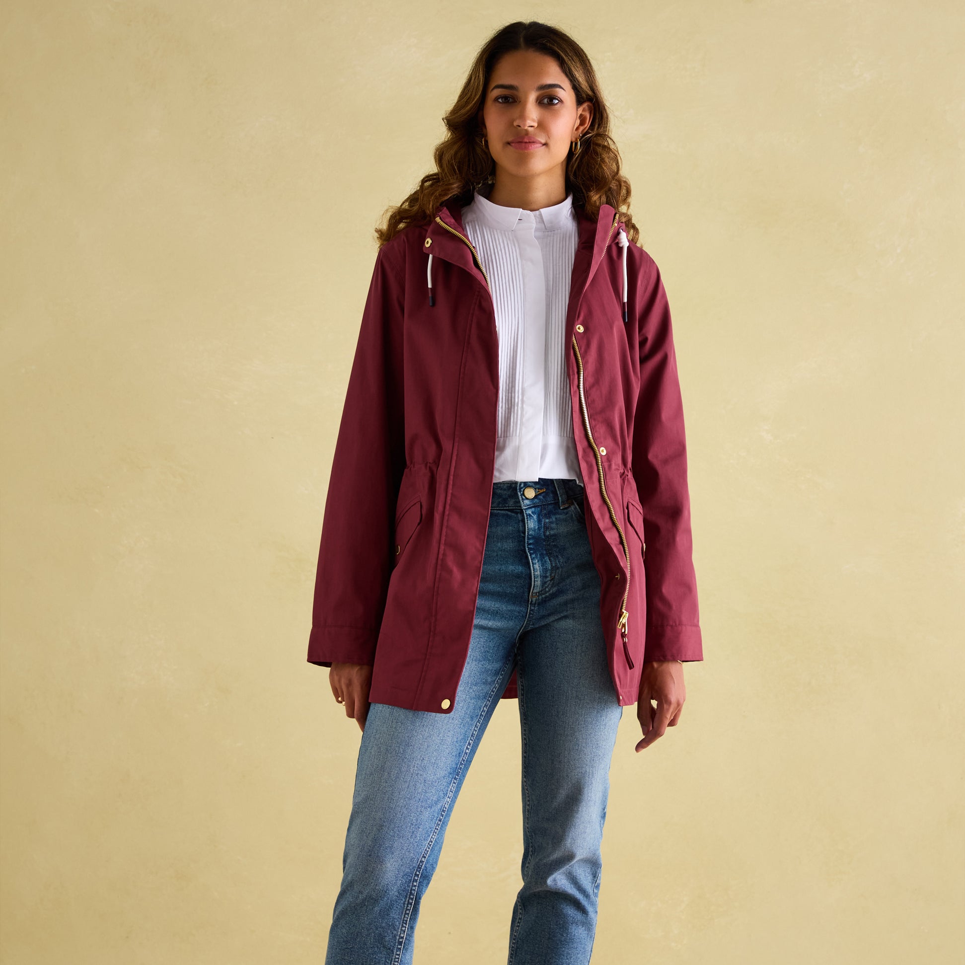 Joules PORTWELL Womens Raincoat Port front view on model, featuring adjustable hood and concealed zipper.