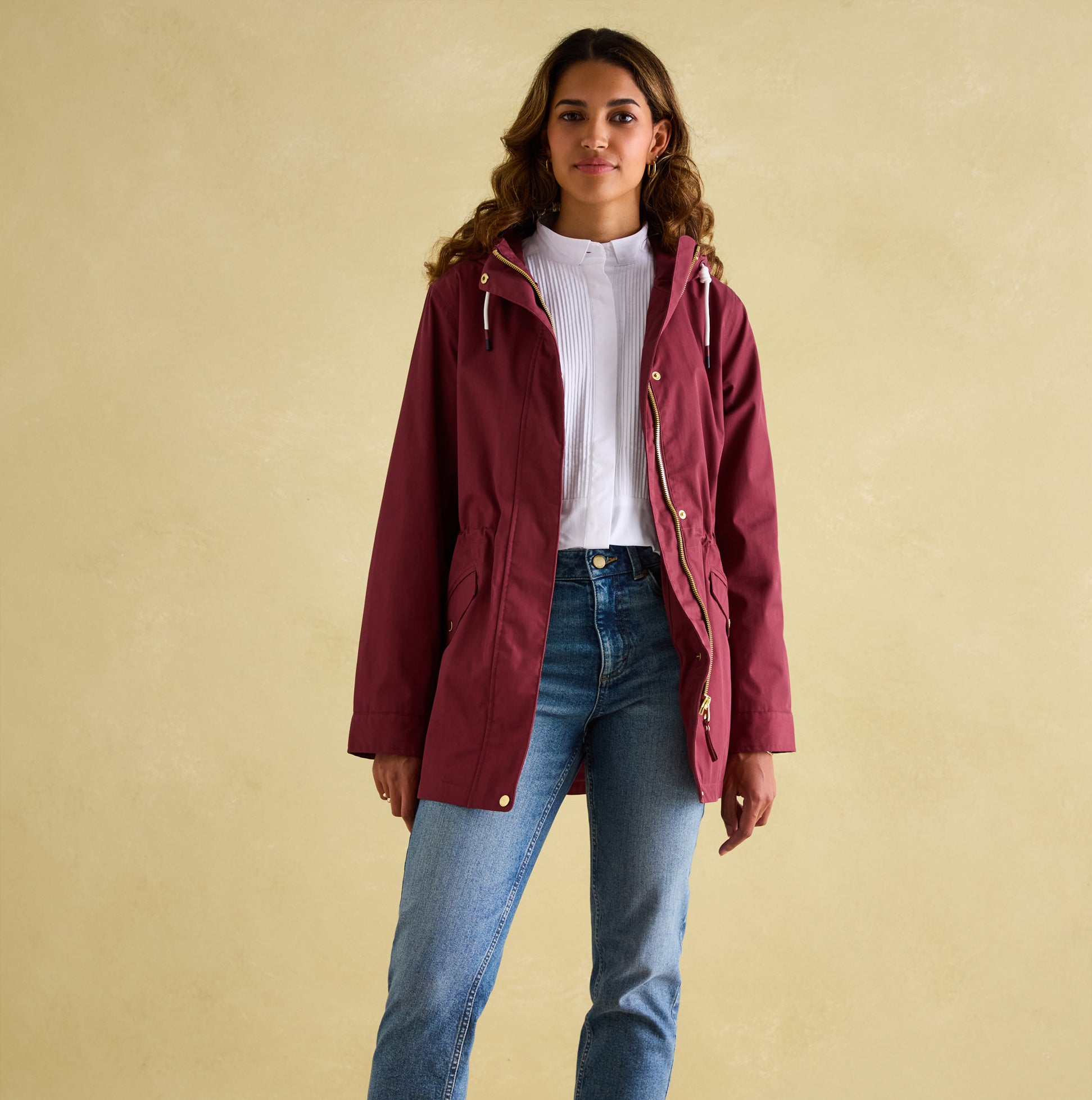 Joules PORTWELL Womens Raincoat Port front view on model, featuring adjustable hood and concealed zipper.