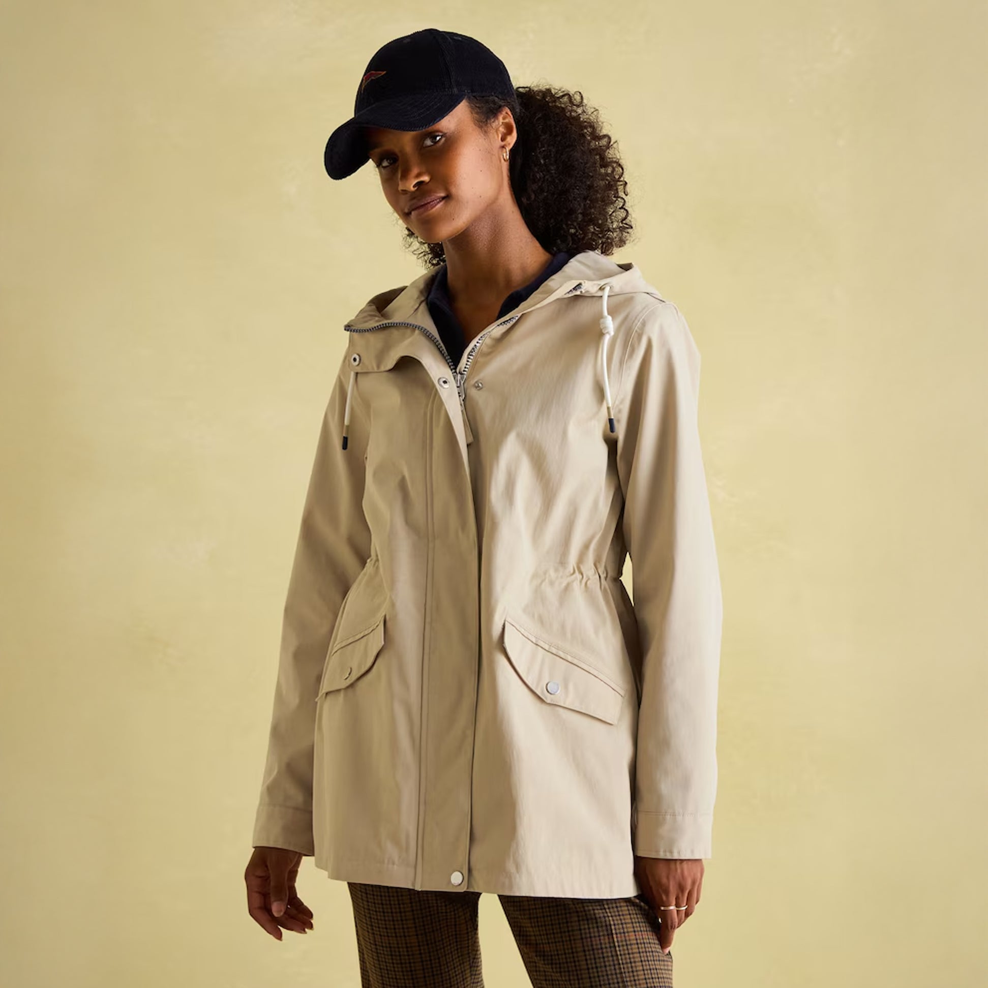 Joules PORTWELL Waterproof Hoodie Raincoat With Adjustable Waist Neutral, front view of model wearing jacket.