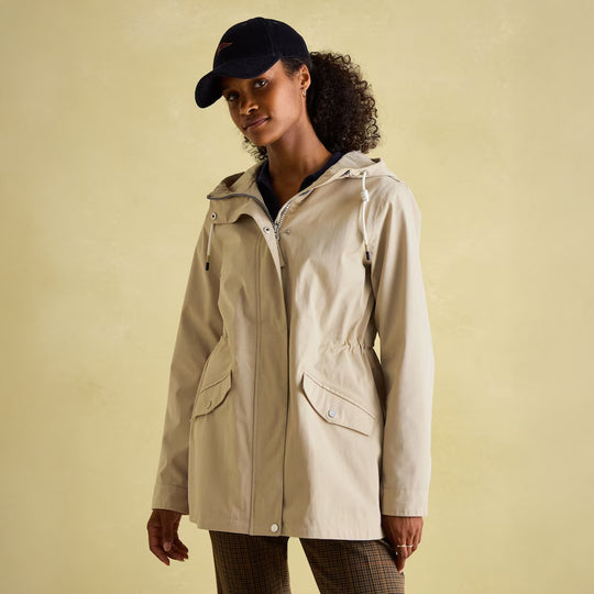 Joules PORTWELL Waterproof Hoodie Raincoat With Adjustable Waist Neutral, front view of model wearing jacket.